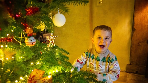 Families discovering the 'The Land of Sweets' themed Christmas decorations in the house at Nymans, West Sussex